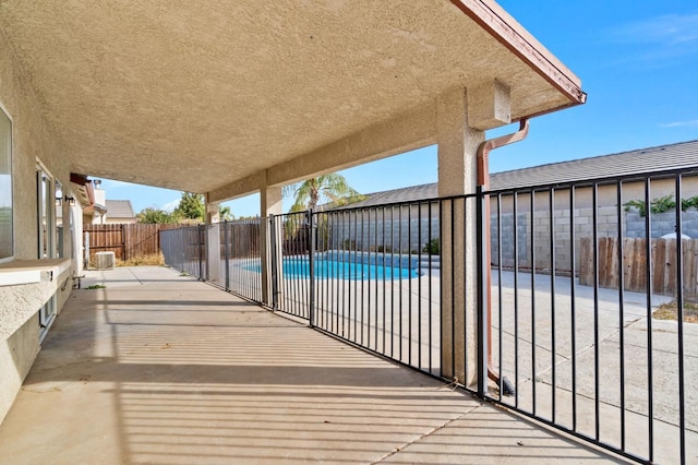 view of patio / terrace with a fenced in pool