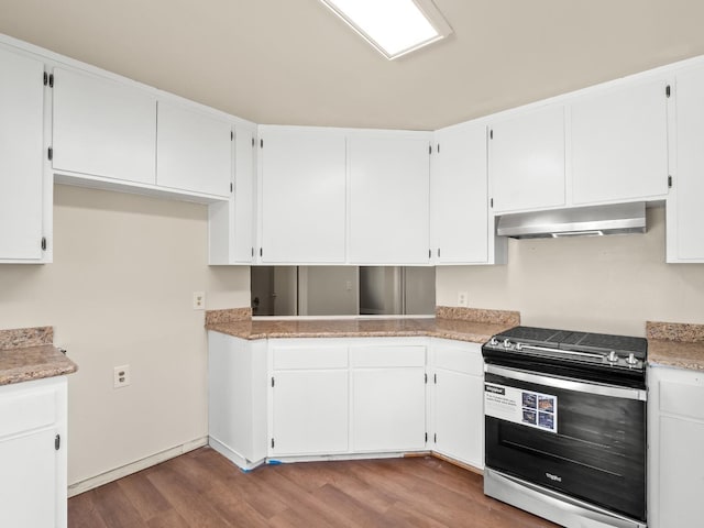 kitchen with white cabinetry, stainless steel range, wood-type flooring, and ventilation hood