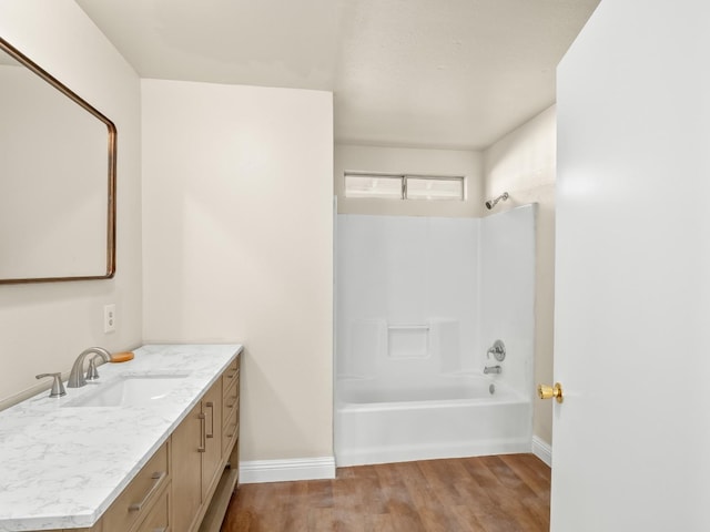 bathroom featuring vanity, hardwood / wood-style flooring, and shower / bathtub combination