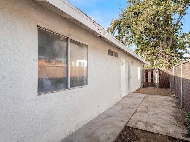 view of side of home featuring a patio area