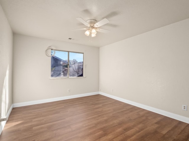 spare room with hardwood / wood-style floors and ceiling fan