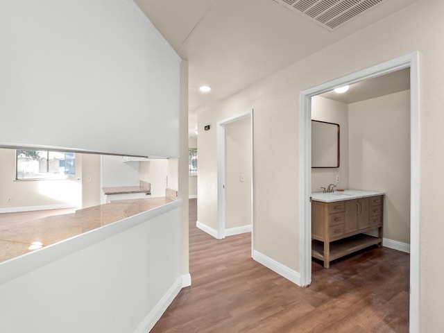 hall featuring dark hardwood / wood-style floors and sink