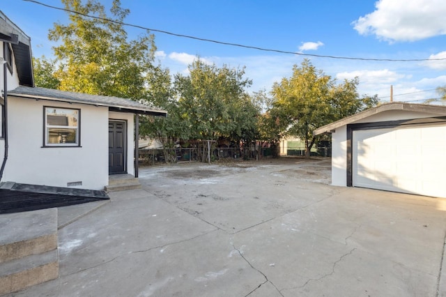 view of patio with a garage and an outdoor structure