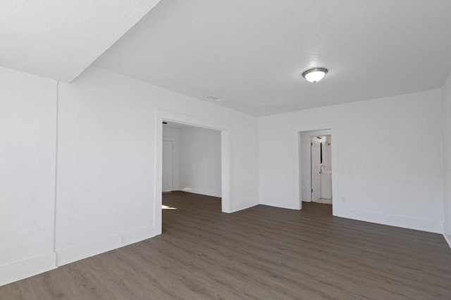 empty room featuring dark hardwood / wood-style flooring