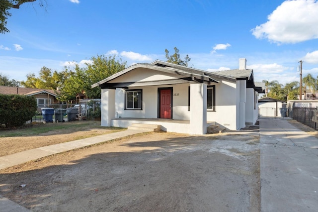 view of front of home with a garage and an outdoor structure