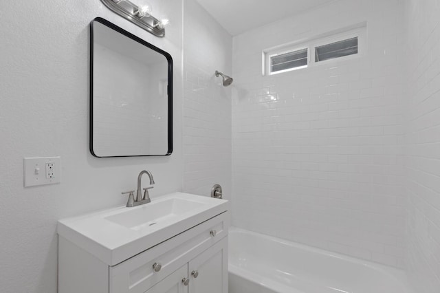 bathroom with vanity and tiled shower / bath