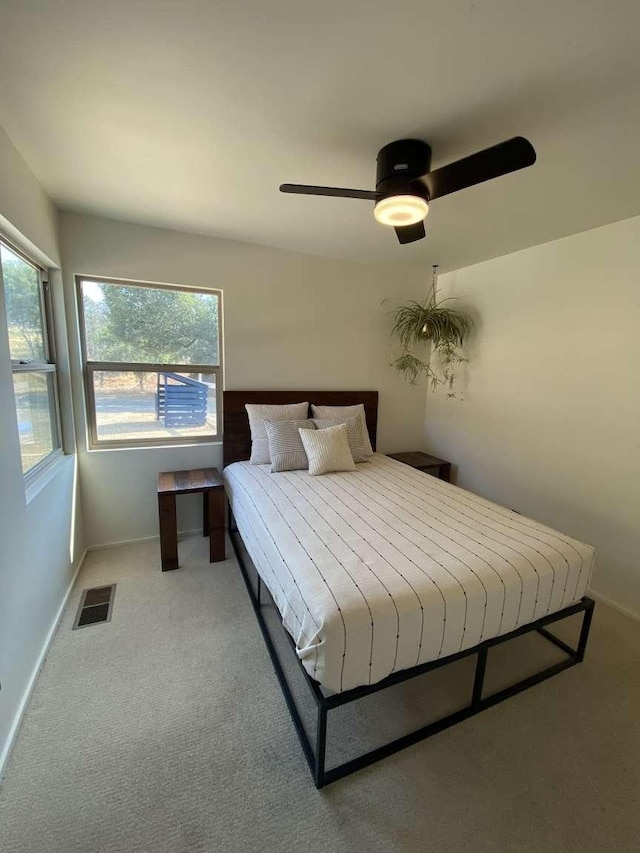 carpeted bedroom with ceiling fan