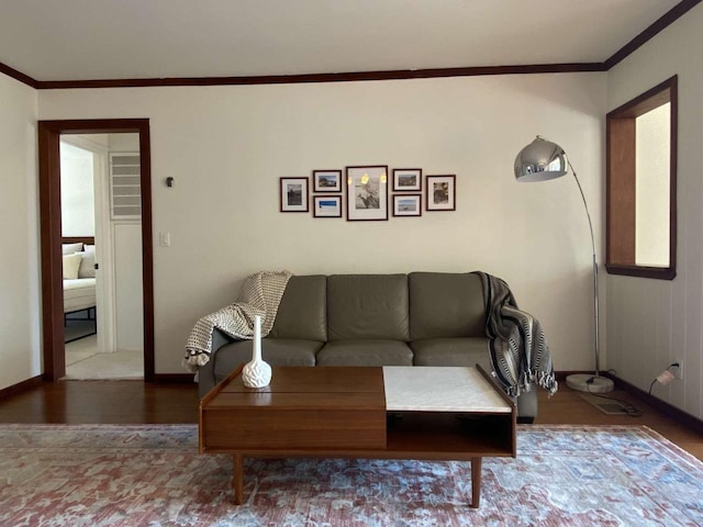 living room with hardwood / wood-style floors and crown molding