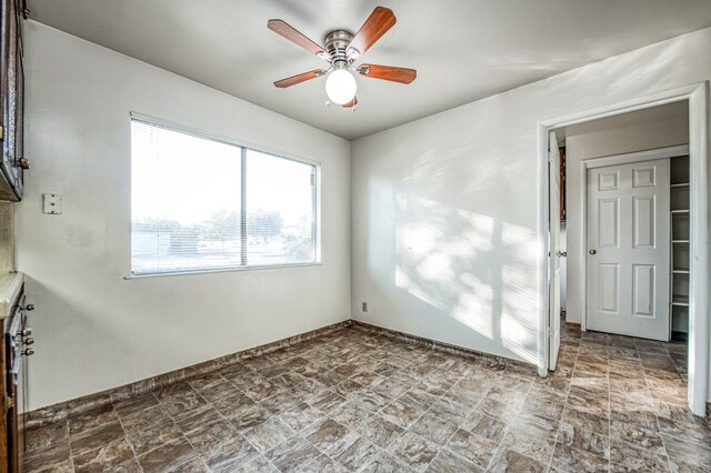 unfurnished room with ceiling fan