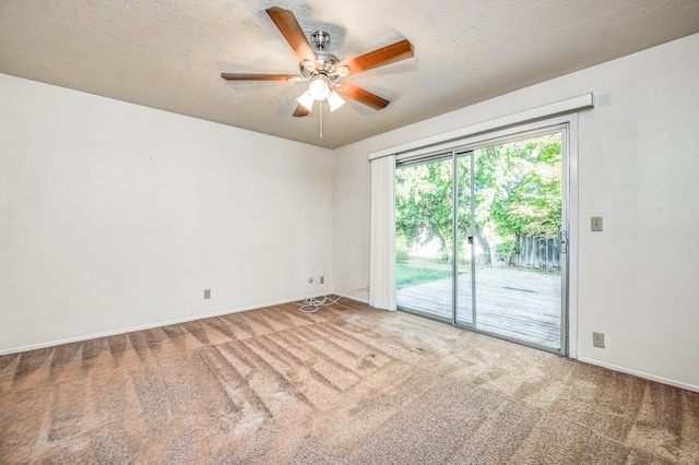 carpeted empty room with a textured ceiling and ceiling fan