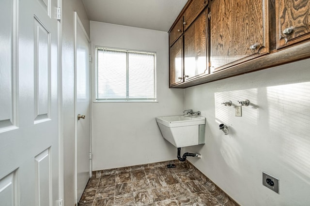 laundry room featuring cabinets and electric dryer hookup