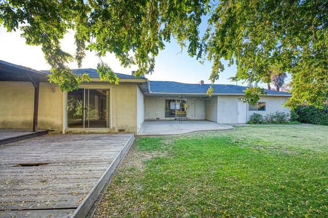 back of house featuring a yard and a patio area