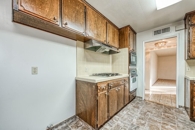 kitchen featuring decorative backsplash and stainless steel appliances