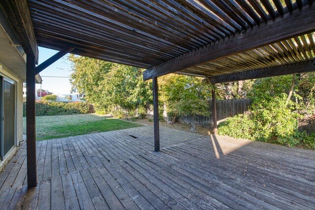 deck featuring a yard and a pergola