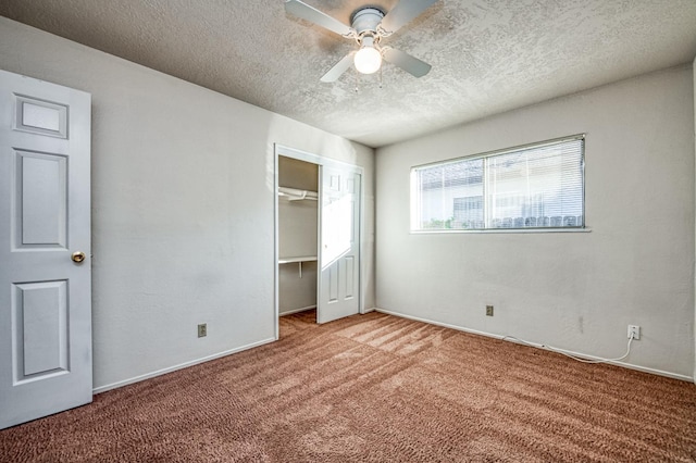 unfurnished bedroom featuring a textured ceiling, carpet, ceiling fan, and a closet