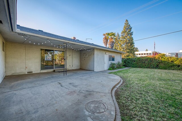 back of house with a yard and a patio area