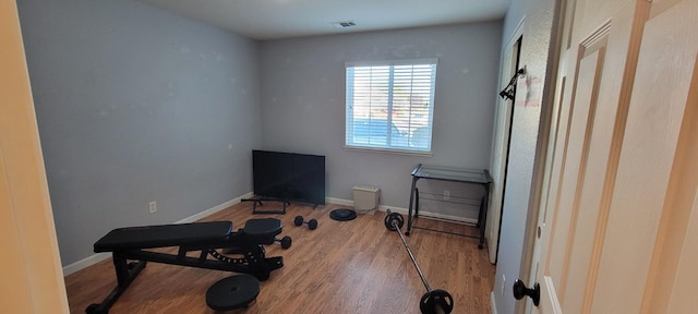 workout area featuring hardwood / wood-style floors