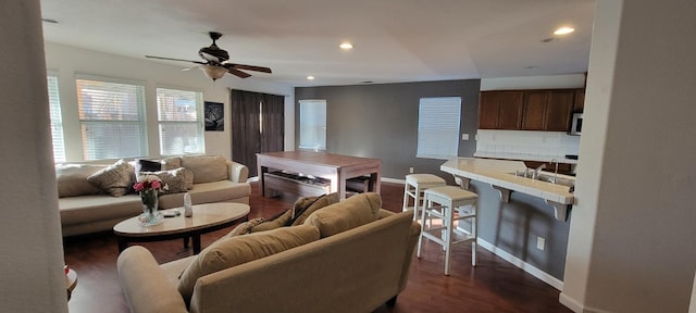 living room featuring ceiling fan, dark hardwood / wood-style floors, and sink