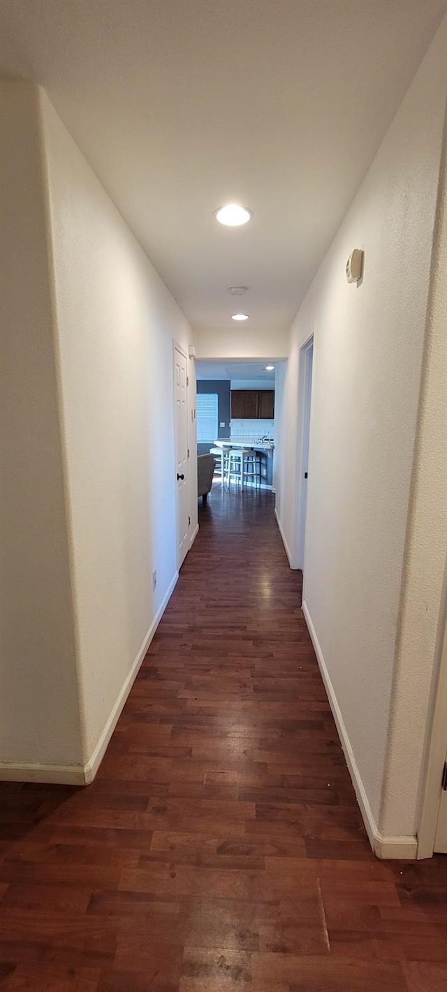 corridor with dark wood-type flooring