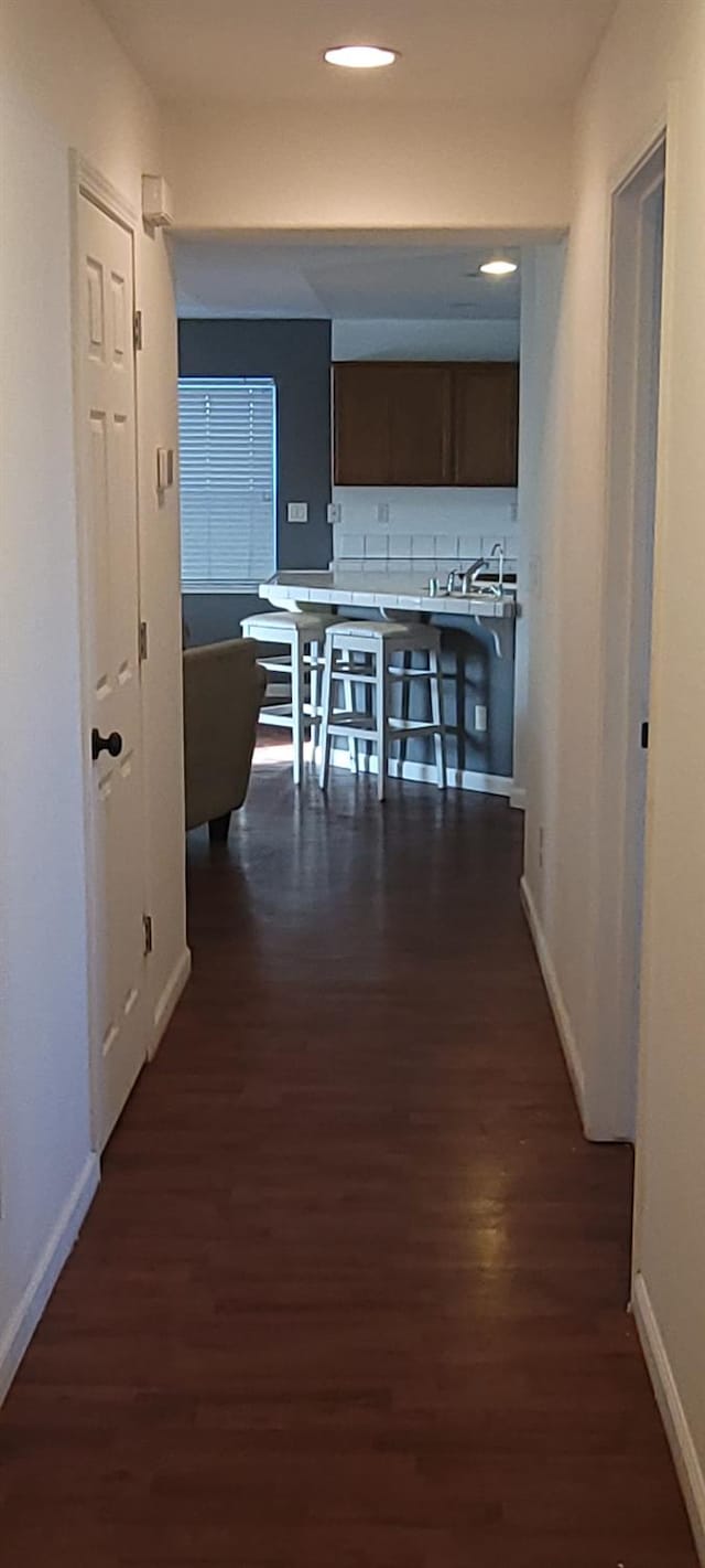 kitchen featuring dark brown cabinetry and dark hardwood / wood-style floors