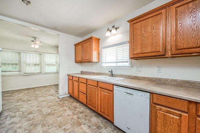 kitchen featuring white dishwasher, sink, and ceiling fan