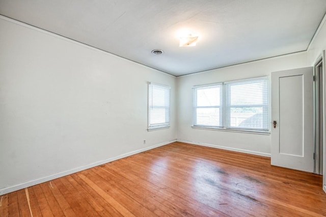 spare room with wood-type flooring