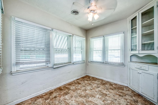 unfurnished dining area with ceiling fan