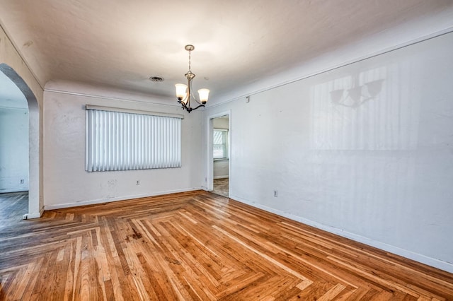 unfurnished dining area featuring parquet floors and an inviting chandelier