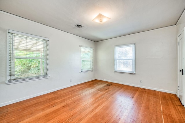 empty room with light hardwood / wood-style flooring