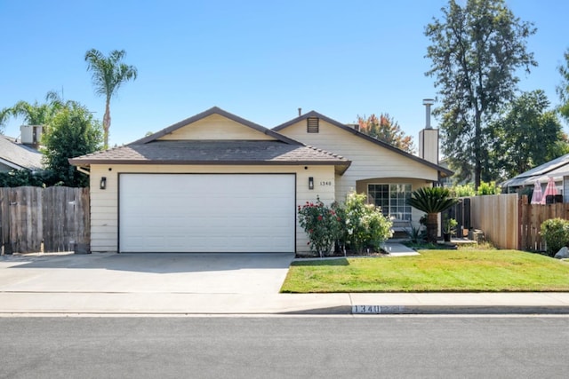 ranch-style house with a garage and a front lawn