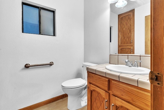 bathroom featuring toilet and vanity