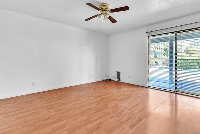 unfurnished room with light hardwood / wood-style floors, ceiling fan, and a textured ceiling