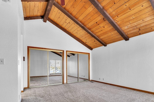 unfurnished bedroom with wood ceiling, high vaulted ceiling, carpet, beam ceiling, and multiple closets