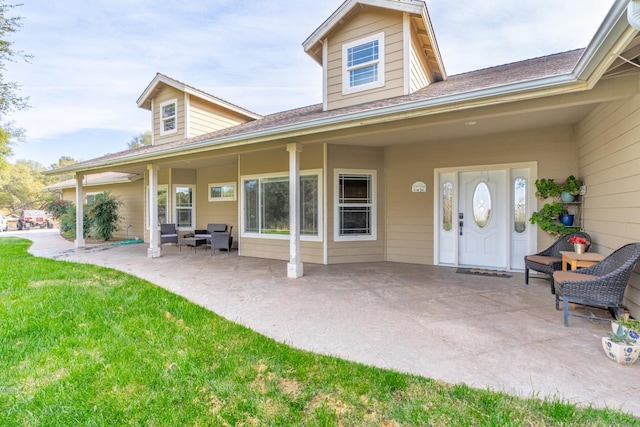 view of exterior entry featuring a yard