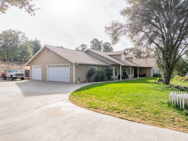 view of front of home with a front yard and a garage