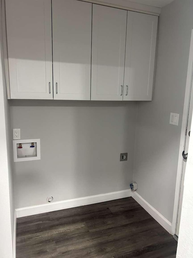 laundry room featuring dark hardwood / wood-style flooring, hookup for a gas dryer, cabinets, washer hookup, and electric dryer hookup