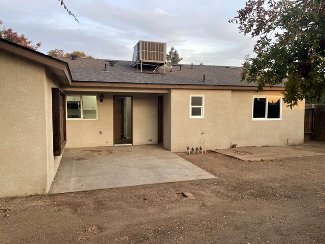 back of property with a patio and central air condition unit