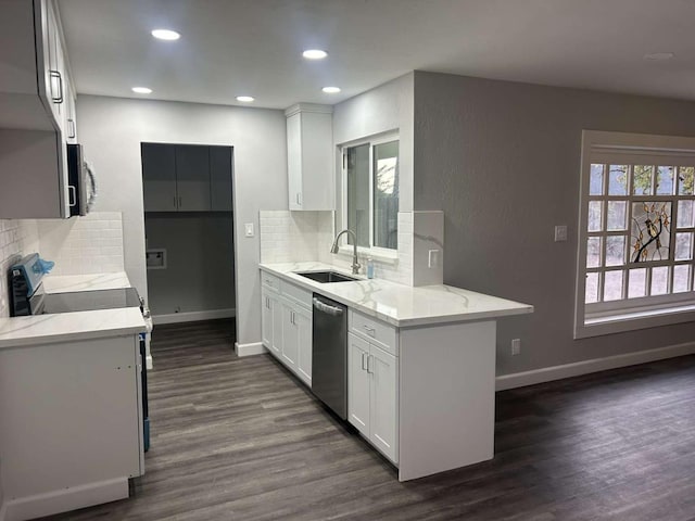 kitchen featuring sink, white cabinetry, stainless steel appliances, light stone counters, and dark hardwood / wood-style flooring