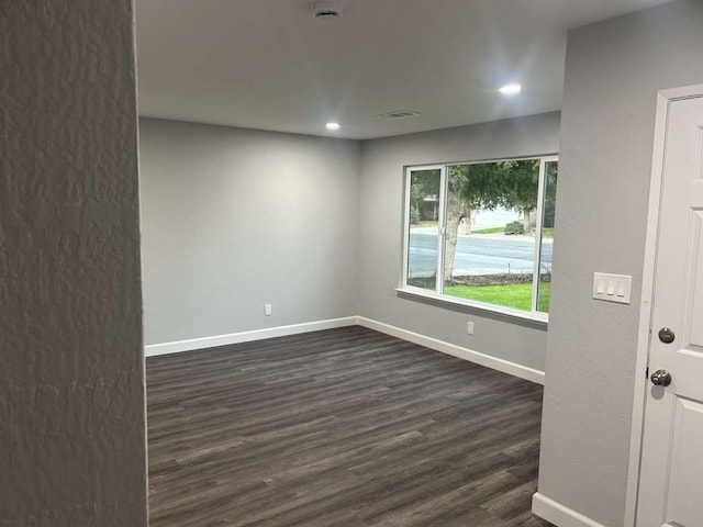 unfurnished room with dark hardwood / wood-style floors