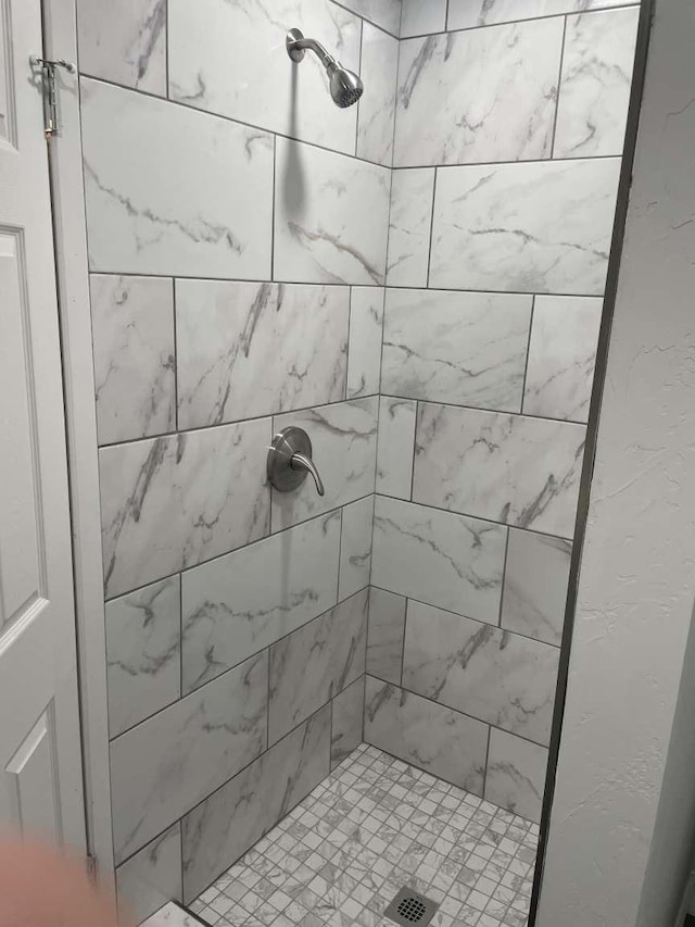 bathroom with a tile shower