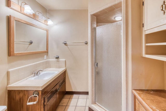 bathroom featuring tile patterned flooring, an enclosed shower, and vanity