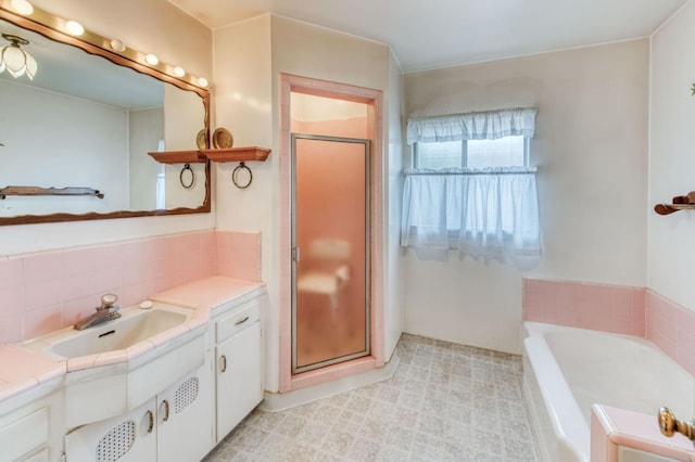 bathroom featuring independent shower and bath and vanity