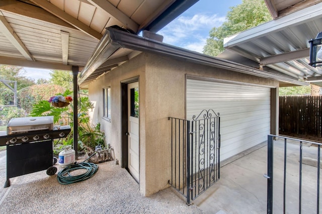 view of patio / terrace with a garage and a grill