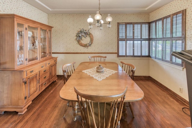 dining space featuring a chandelier and dark hardwood / wood-style floors