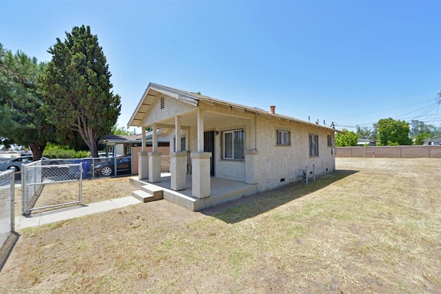 exterior space featuring a front lawn and a patio