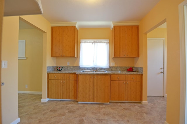 kitchen featuring light stone countertops and sink