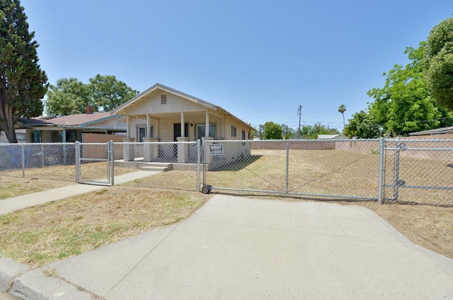 339 N Delno Ave, Fresno, CA 93706 - view of front of home featuring a gate, a fenced front yard, stucco siding, and covered porch