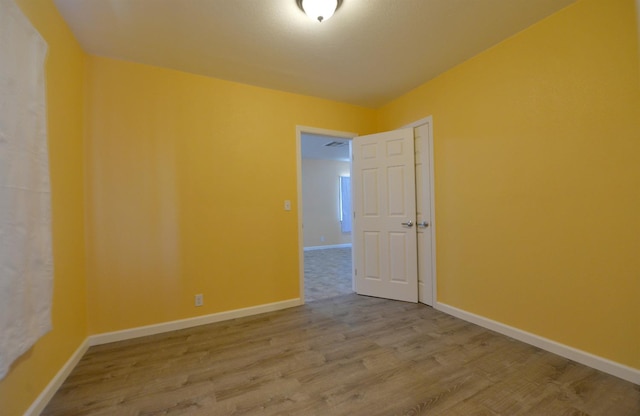 unfurnished room featuring light hardwood / wood-style flooring