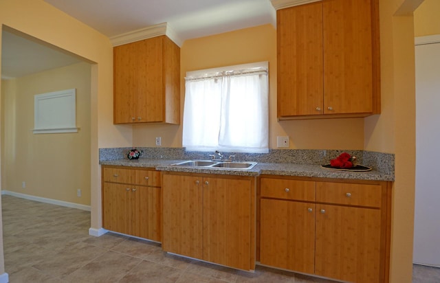339 N Delno Ave, Fresno, CA 93706 - kitchen featuring a sink, brown cabinetry, and baseboards