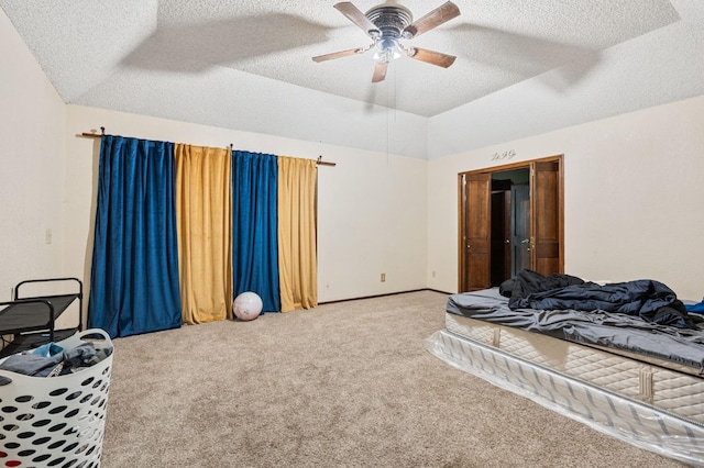 bedroom with a textured ceiling, carpet floors, and ceiling fan